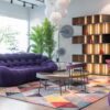 modern decorated house with purple sofa and wooden racks