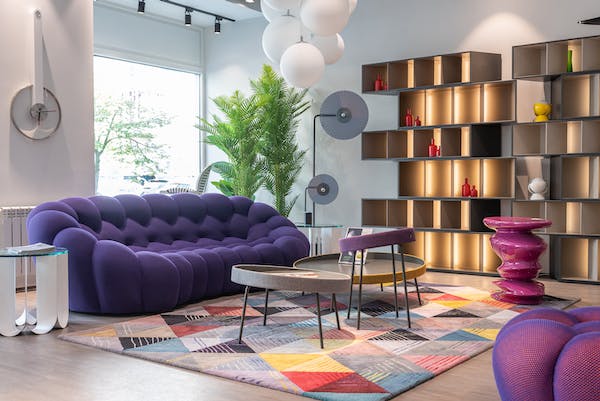 modern decorated house with purple sofa and wooden racks